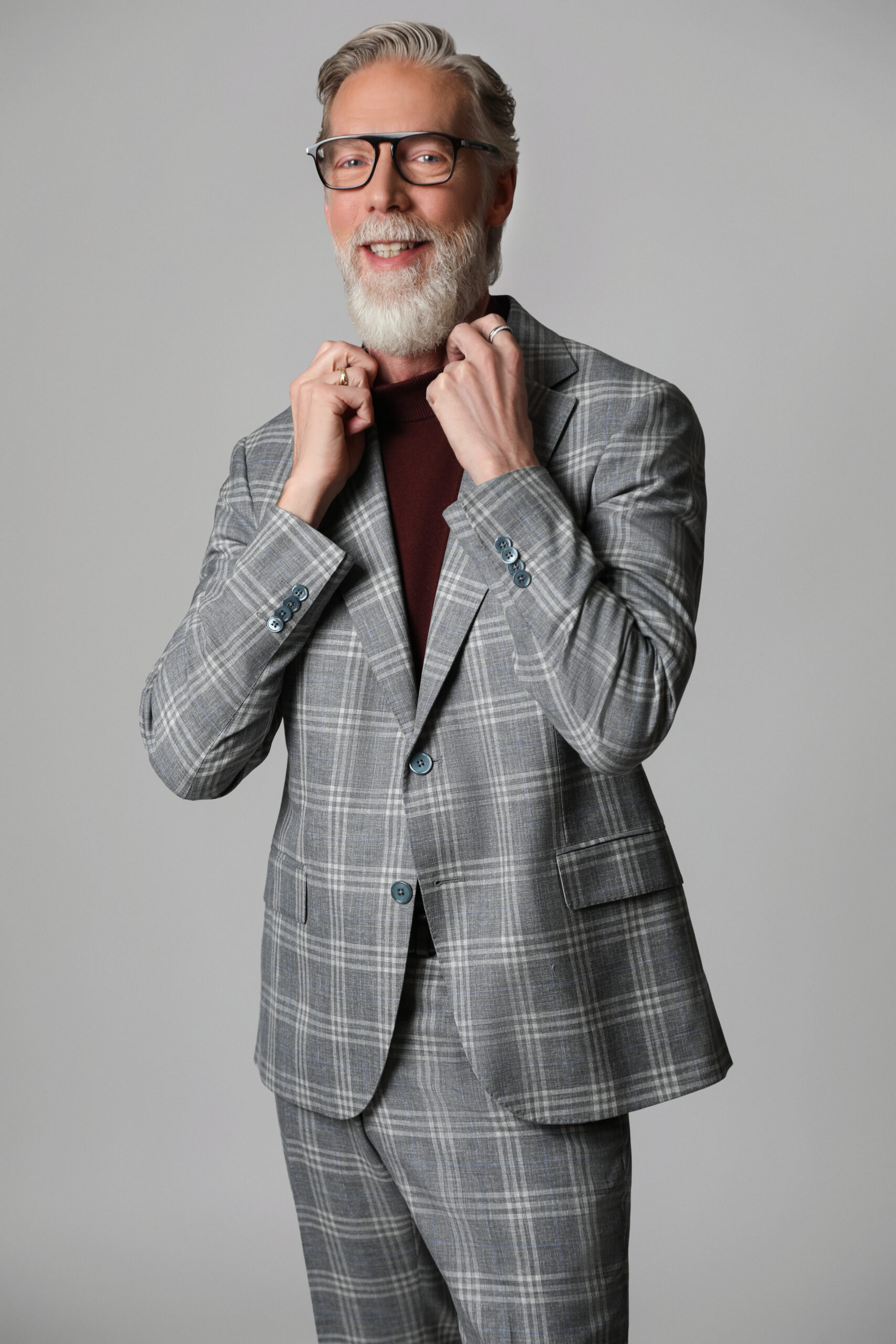 Fashion editorial portrait of Toronto-based model and hair artist Gordon Douglas wearing a grey tailored suit