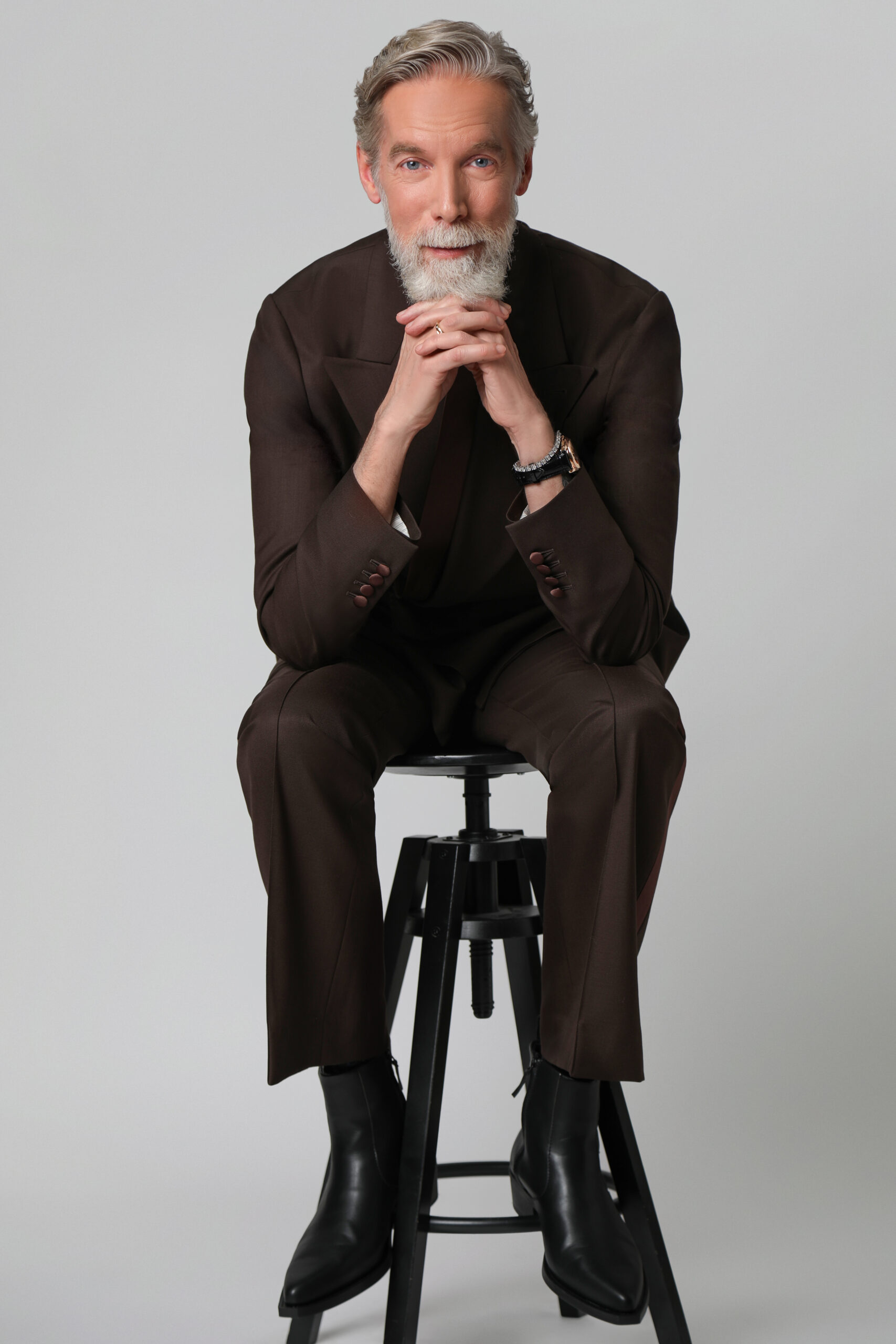 Fashion editorial portrait of Toronto-based model and hair artist Gordon Douglas wearing a grey tailored suit