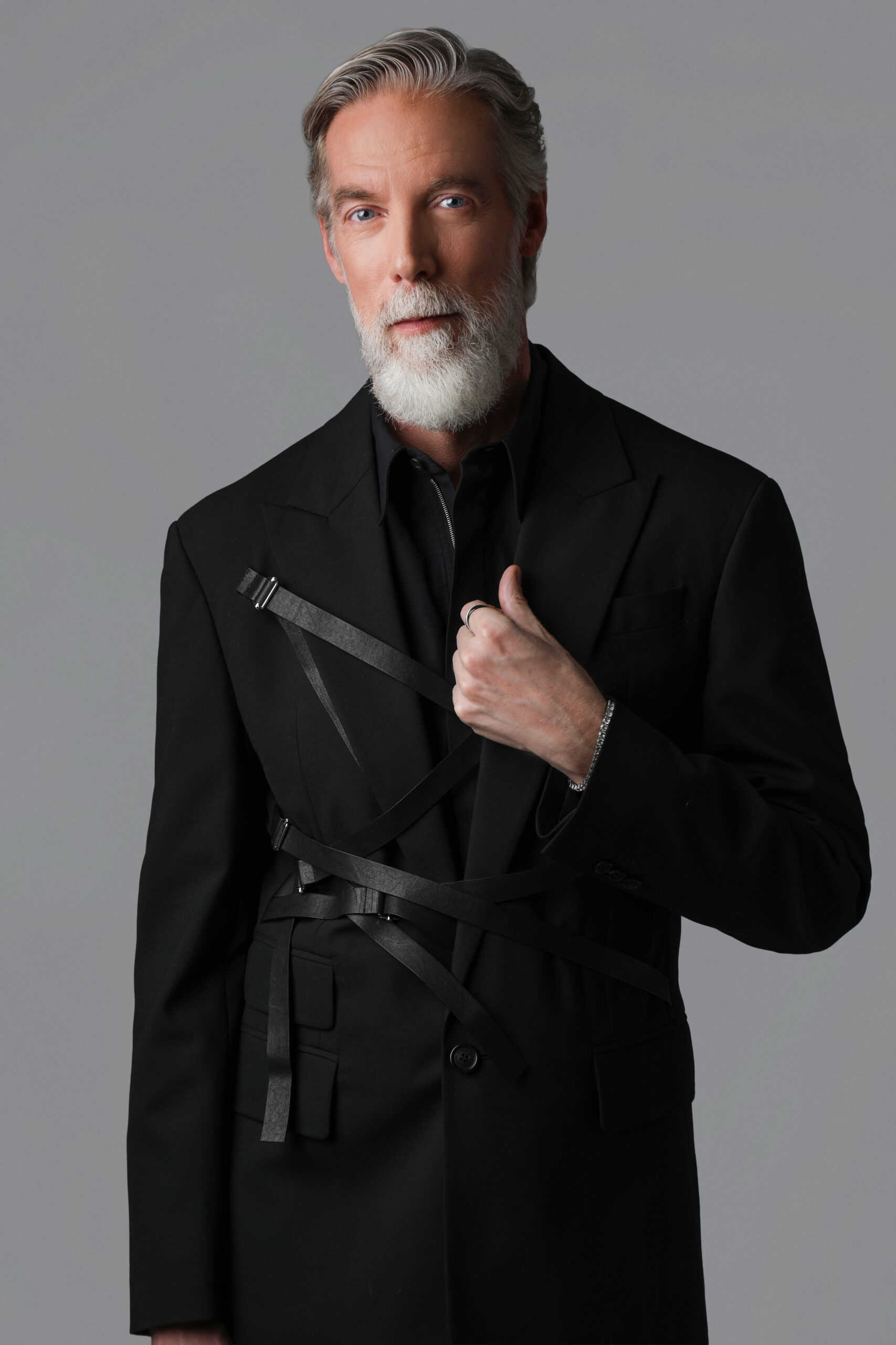 Model and hair artist Gordon Douglas wearing black designer outfit in editorial shoot
