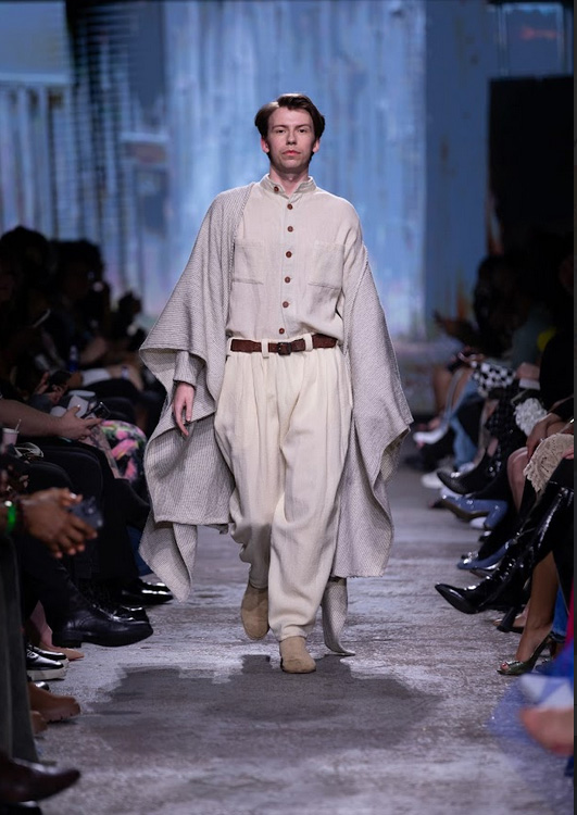 Model walking the runway in sustainable wool outfit by Wave Fibre Mill, showcasing eco-friendly fashion and minimalist design at RunwayTO.