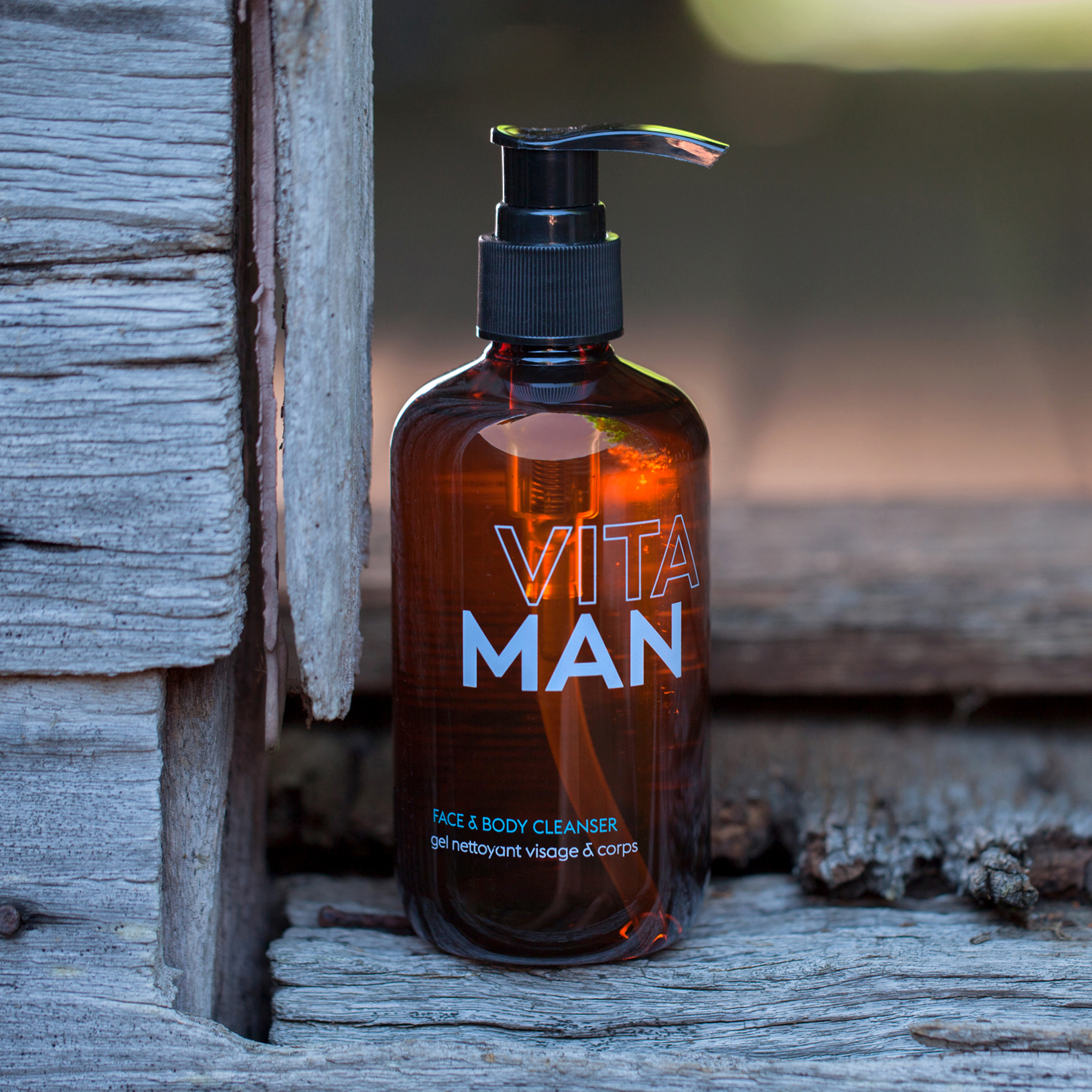 VITAMAN face and body cleanser for men’s skincare placed on rustic wooden background