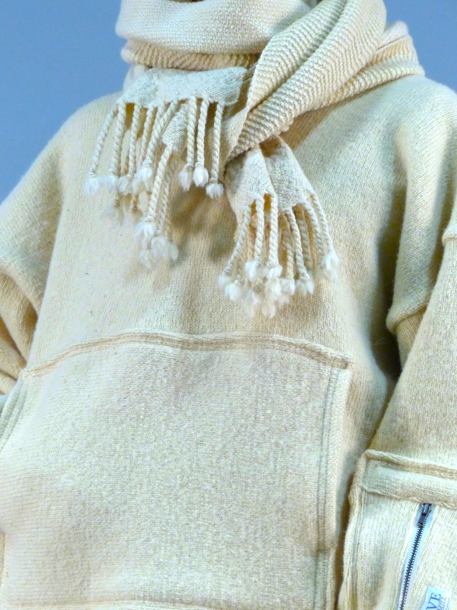 Close-up of handmade wool scarf and sweater by Wave Fibre Mill, featuring natural fibers, ethical craftsmanship, and sustainable Canadian fashion.
