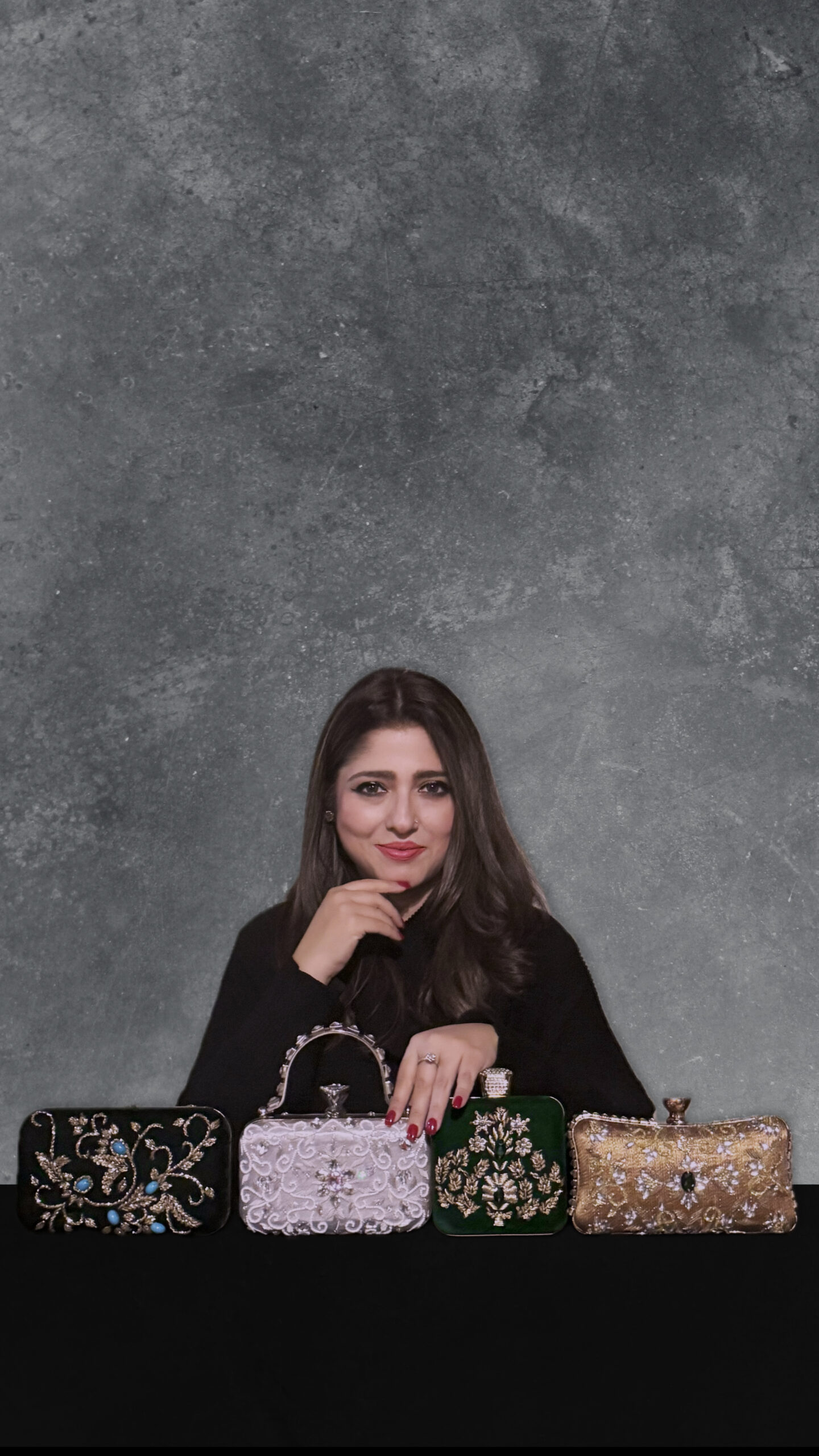 Sana Ehtasham, Canadian fashion designer and founder of SANA EHTASHAM, photographed with the Love Letters clutch collection