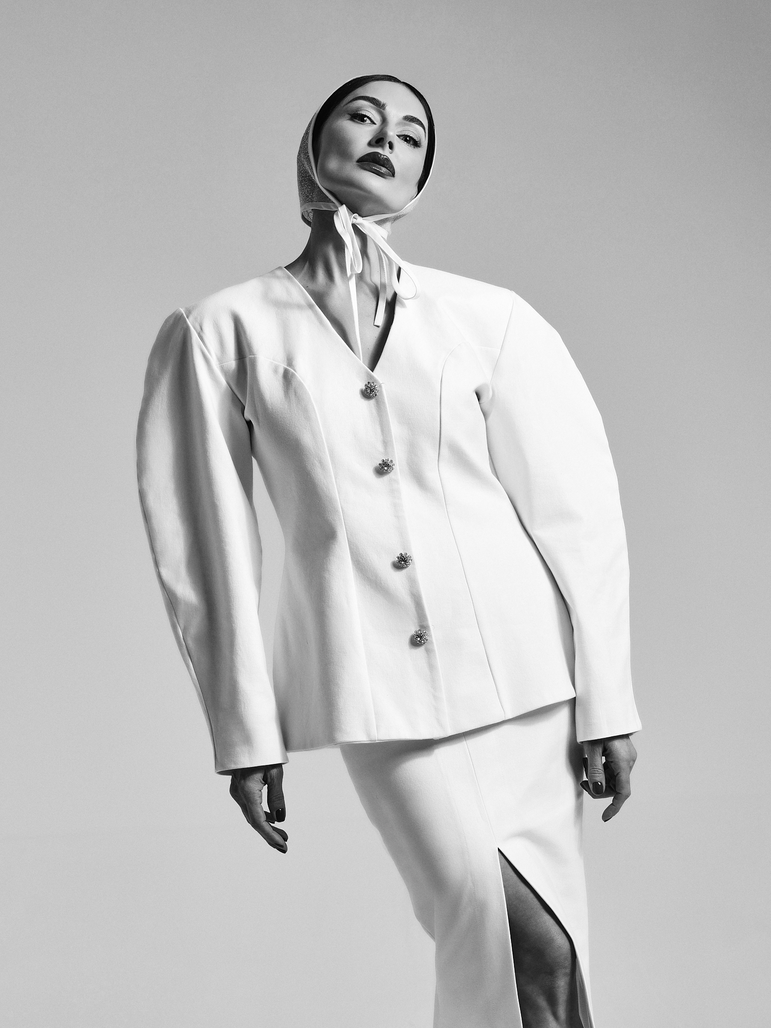 Model wearing a sculptural white GUROSI look with clean lines and minimalist silhouette.