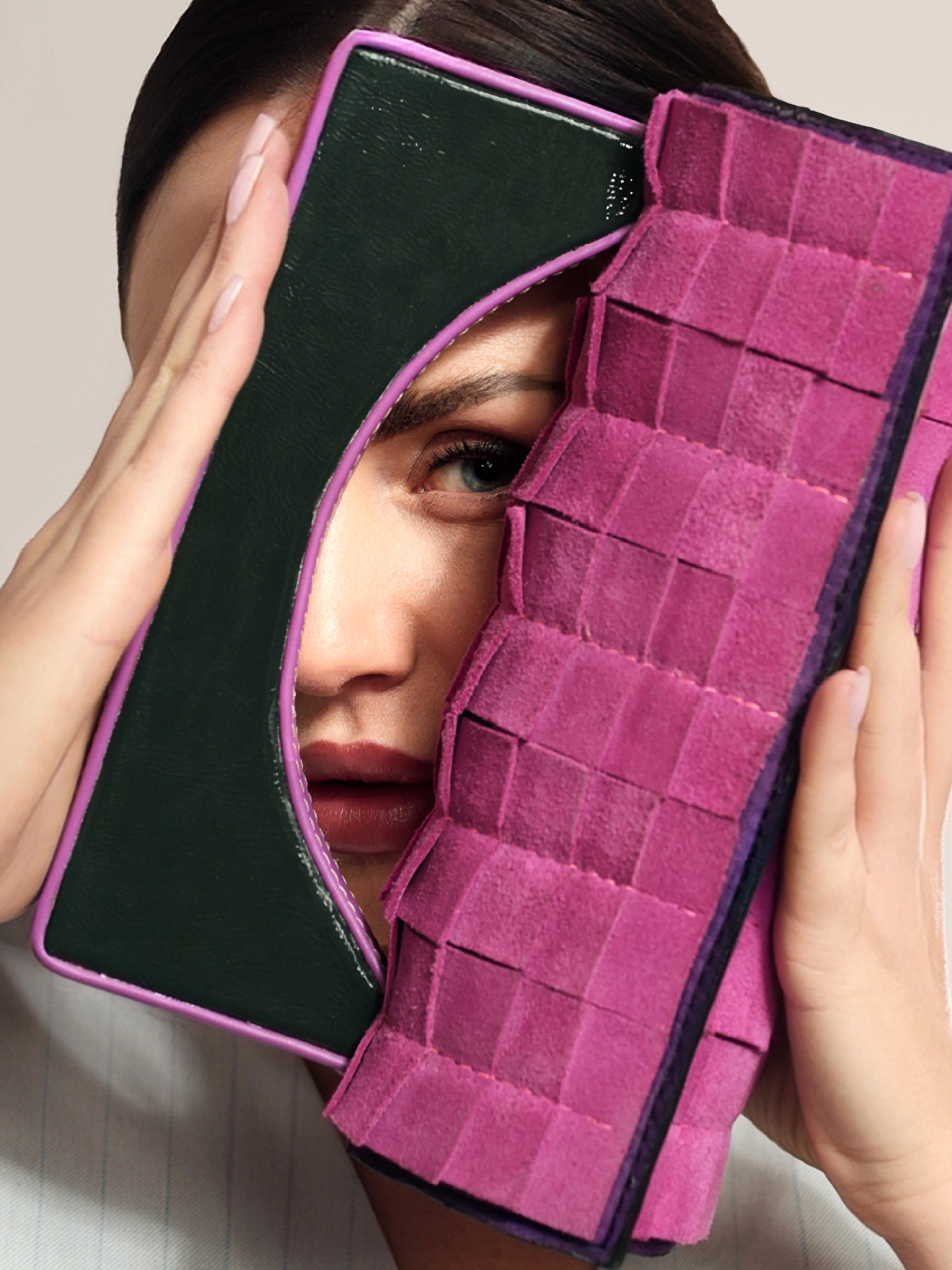 Close-up portrait highlighting a handcrafted GUROSI bag with textured detailing and bold color accents.