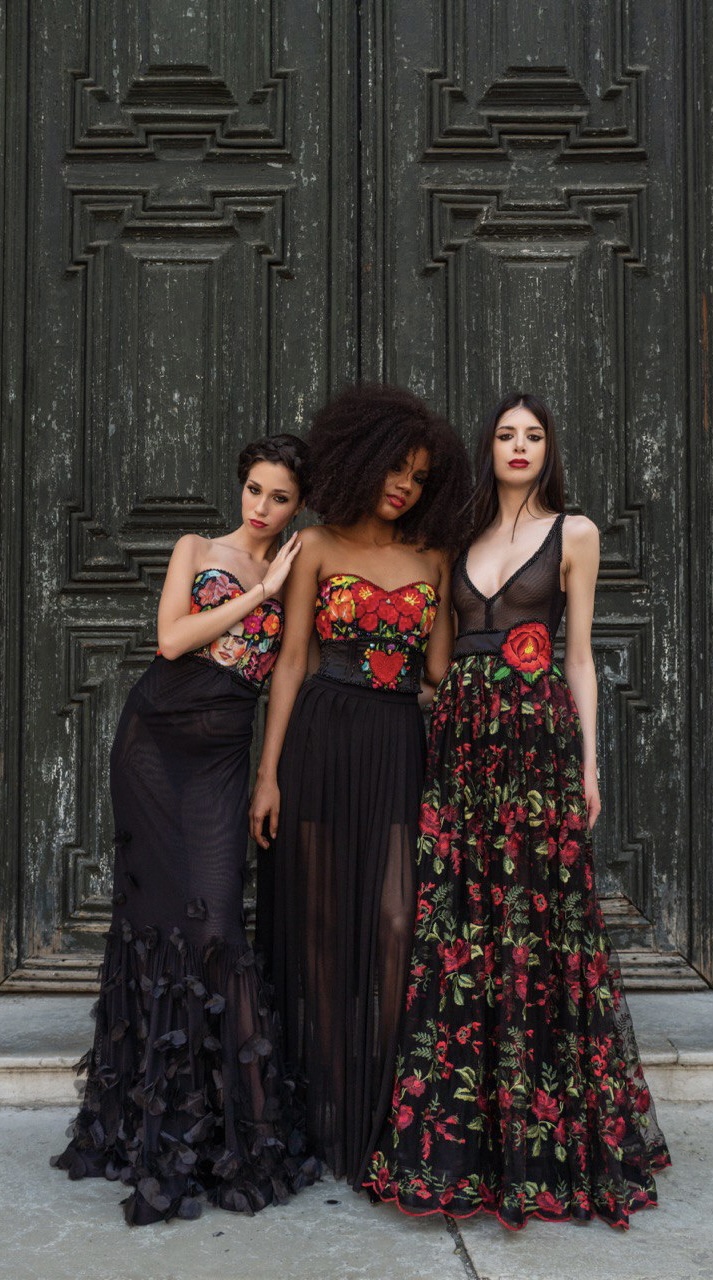 Three models wearing black couture dresses with floral embroidery by Atelier Ancheita Italy for Milan Women’s Fashion Week FW 2026–2027