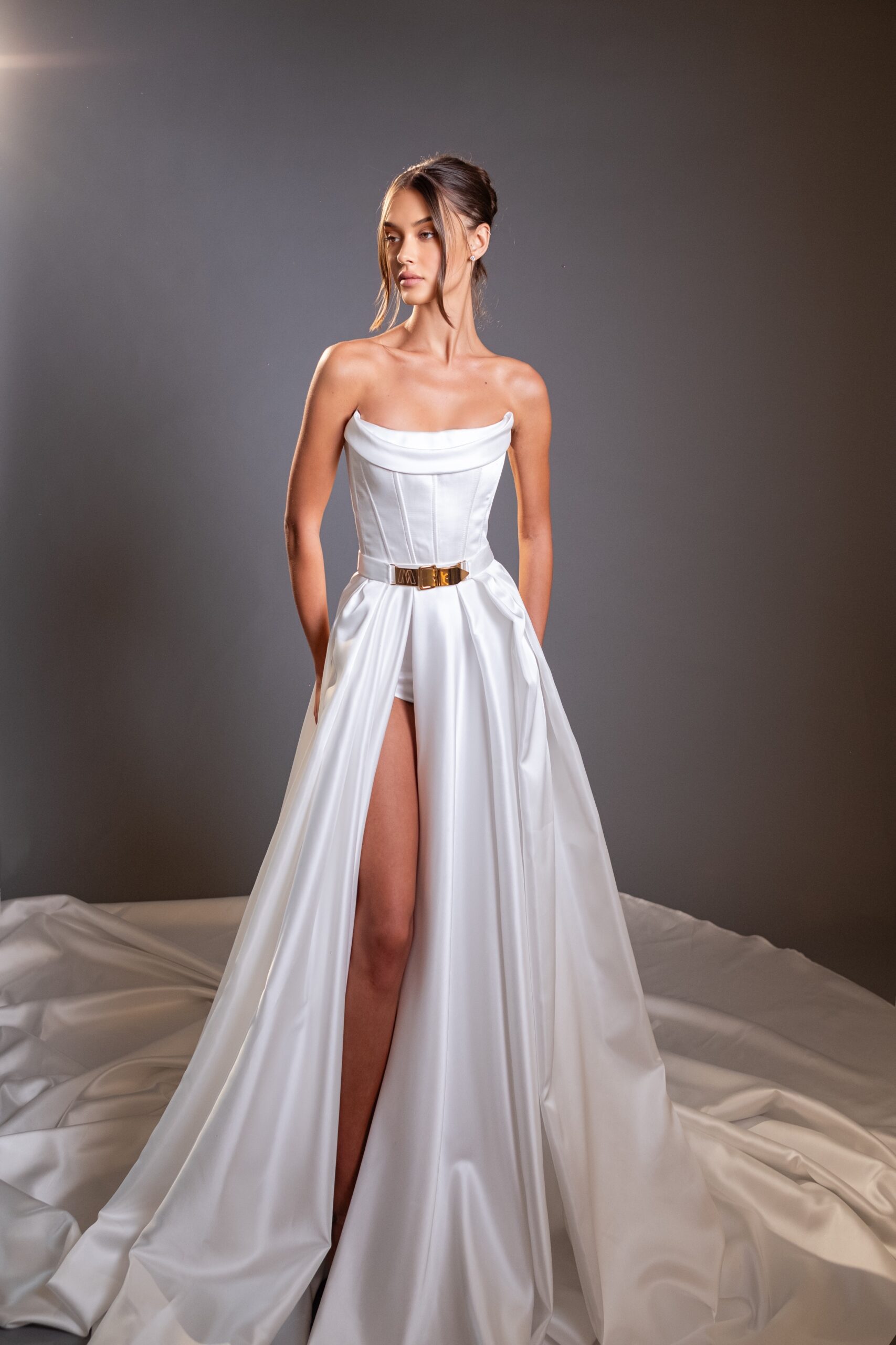 Modern bridal couture look by Moran Tubul Couture with strapless corset, high slit skirt, and minimalist silhouette from the “Queen of Brides” collection, Milan Fashion Week FW 2026–2027.