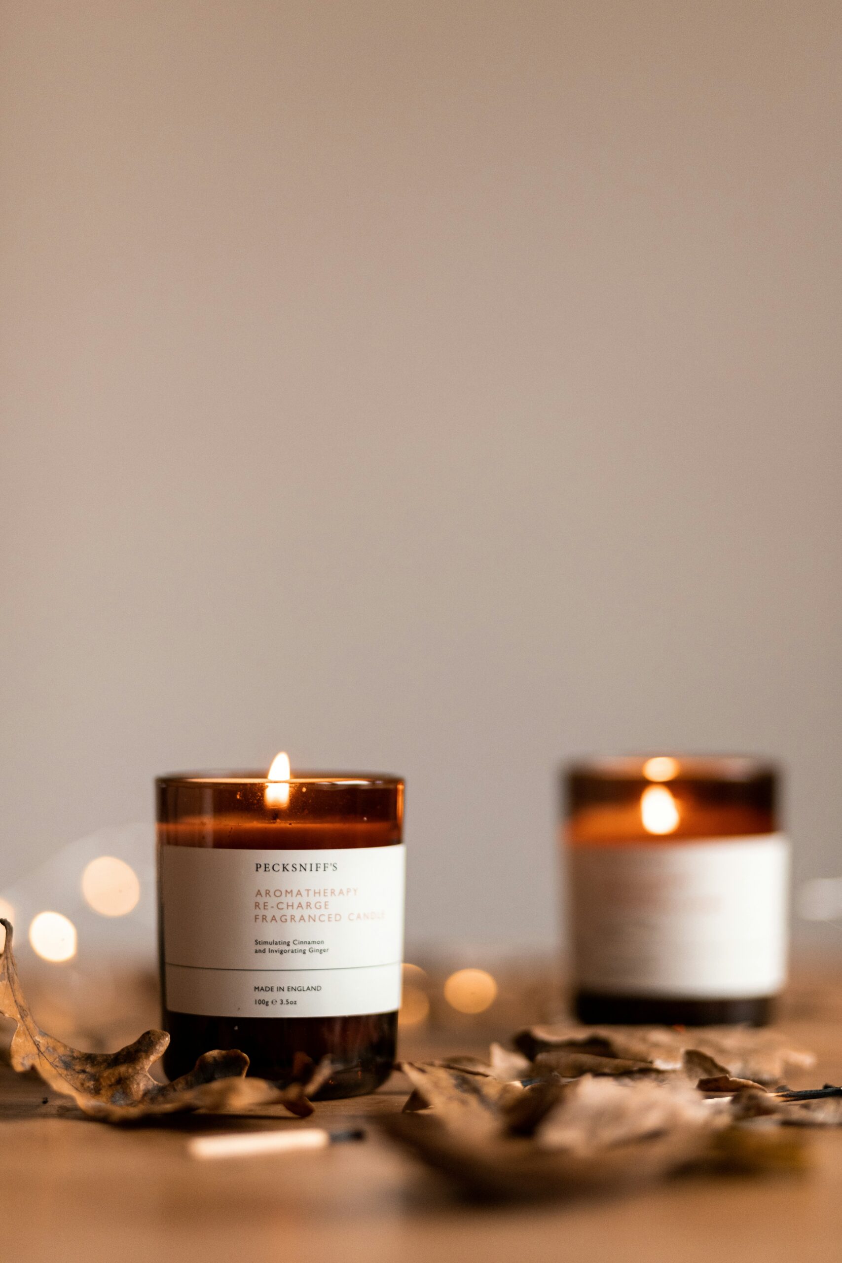 Lit scented candles on a table creating a cozy home atmosphere with warm ambient light