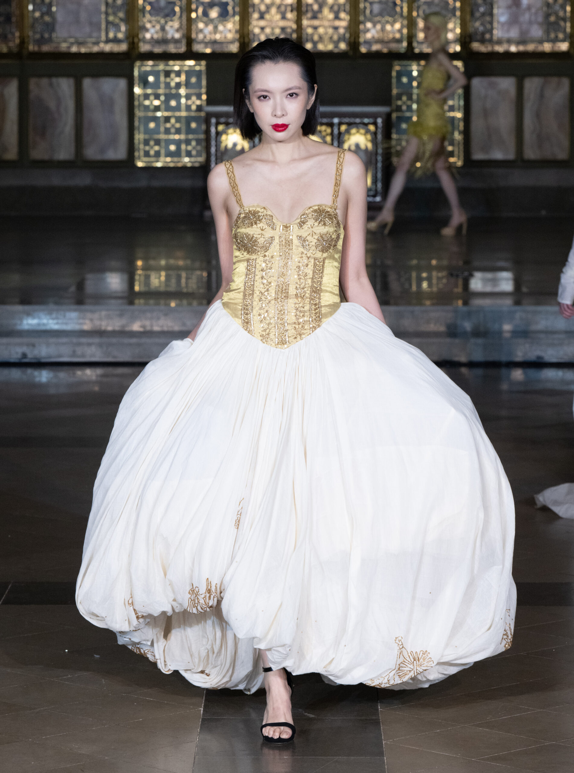 Fashion Week and the City Spotlight Series — gold embroidered corset with voluminous white ball skirt at London Fashion Week AW2026, St John's Church, Hyde Park.