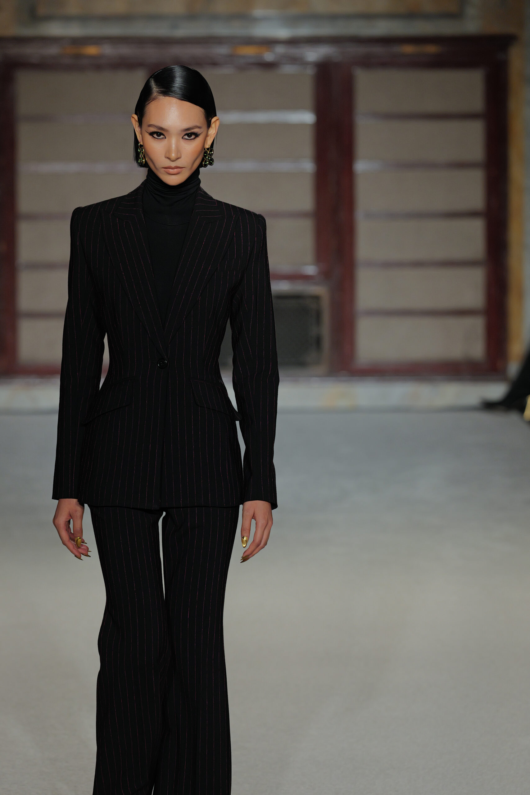 Black pinstripe suit turtleneck power dressing tailored silhouette Sergio Hudson NYFW 2026